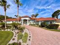 Luxury home with red tile roof and landscaped yard at 4571 Lake In The Woods Dr, Spring Hill, FL 34607