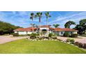 Luxury home with red tile roof and manicured landscaping at 4571 Lake In The Woods Dr, Spring Hill, FL 34607