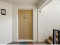Beige front door with a doormat, leading into a condo unit at 3232 Lake Pine E Way # H2, Tarpon Springs, FL 34688