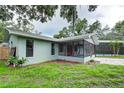 Home exterior showcasing screened porch and pool at 1423 Meadow Lark Rd, Spring Hill, FL 34608