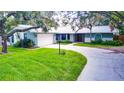 House with lush lawn and driveway at 1423 Meadow Lark Rd, Spring Hill, FL 34608