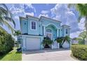 Two-story light blue house with three car garage at 4260 Columbus Dr, Hernando Beach, FL 34607