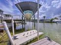 Covered boat lift and floating dock at 4260 Columbus Dr, Hernando Beach, FL 34607