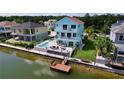 Two-story waterfront home boasts a private pool and dock at 3423 Palometa Dr, Hernando Beach, FL 34607