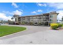 Exterior view of a multi-story building with covered parking and landscaped grounds at 4632 Marine Pkwy # 302, New Port Richey, FL 34652