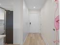 Hallway with hardwood floors, a flamingo painting and stainless steel refrigerator at 4632 Marine Pkwy # 302, New Port Richey, FL 34652