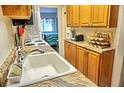 Updated kitchen with wood cabinets and granite counters at 1955 Abrico Dr # G7, Lutz, FL 33558