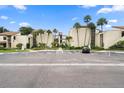 Condo building with parking and tropical landscaping at 2207 Belleair Rd # A32, Clearwater, FL 33764
