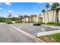 Condo building with parking and tropical landscaping at 2207 Belleair Rd # A32, Clearwater, FL 33764