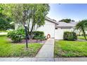 Exterior view showing landscaping and walkway at 2727 Featherstone Dr # 2727, Holiday, FL 34691