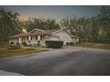 Ranch-style home with brick facade, attached garage, and picnic table at 4148 Batten Rd, Brooksville, FL 34602