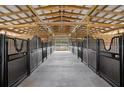 Spacious barn with multiple horse stalls and a wide aisle at 4148 Batten Rd, Brooksville, FL 34602
