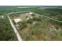 Aerial view of a rural property with a house, barn, and pastures at 4148 Batten Rd, Brooksville, FL 34602