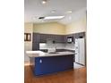 Modern kitchen with a large island and dark gray cabinets at 6336 Wooden St, New Port Richey, FL 34653
