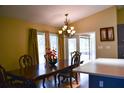 Bright dining room with a wood table and access to a screened porch at 6336 Wooden St, New Port Richey, FL 34653