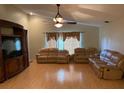 Spacious living room featuring hardwood floors and comfortable leather sofas at 6336 Wooden St, New Port Richey, FL 34653