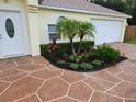 Exterior view of the house's entrance with landscaping at 6075 Shingler Ave, Spring Hill, FL 34608
