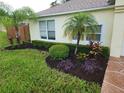Exterior view of the home's side with landscaping at 6075 Shingler Ave, Spring Hill, FL 34608