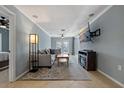 Bright living room featuring comfortable seating and large TV at 9 Grace St, Crystal Beach, FL 34681