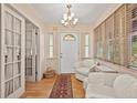 Bright and airy entryway with hardwood floors and comfortable seating at 1501 28Th N Ave, St Petersburg, FL 33704