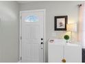Bright entryway with white door and storage cabinet at 3124 Lecanto St, Holiday, FL 34691