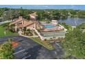 Aerial view of community pool, shuffleboard courts, and clubhouse at 3849 Staysail Ln, Holiday, FL 34691