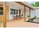 Inviting front porch with wooden posts and seating area at 1108 66Th Nw St, Bradenton, FL 34209