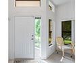 Bright entryway with white door and large windows at 9108 Bassett Ln # B, New Port Richey, FL 34655