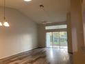 Living room with wood-look floors and sliding doors at 2839 Featherstone Dr, Holiday, FL 34691