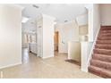 Open living room with tile floors and access to kitchen and stairs at 5614 Red Snapper Ct, New Port Richey, FL 34652