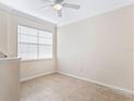 Well-lit bedroom with tile floors and a window with blinds at 5614 Red Snapper Ct, New Port Richey, FL 34652