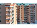 Exterior view of a light peach colored condominium building with balconies and waterfront access at 4516 Seagull Dr # 414, New Port Richey, FL 34652