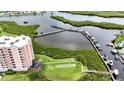 Aerial view of waterfront property with a condo, boat docks, and lush greenery at 4516 Seagull Dr # 414, New Port Richey, FL 34652