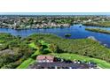 Aerial view of condo building parking lot with waterfront and community building views at 4516 Seagull Dr # 414, New Port Richey, FL 34652