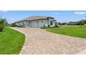 Spacious paved driveway leading to a two-car garage at 9237 Palm Beach Dr, Spring Hill, FL 34613