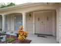 Inviting front entrance featuring a double door, decorative plants, and covered porch at 12307 Fieldstone Ln, Hudson, FL 34667