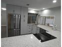 Modern kitchen with stainless steel appliances and white cabinets at 12313 Larkinwood Ln, Hudson, FL 34667