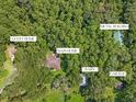 Aerial view showing main house, guest house, barn and other buildings at 21360 Race Horse Ln, Brooksville, FL 34604