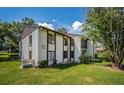 Condo building with multiple units and a parking lot at 2522 Pine Ridge S Way # A2, Palm Harbor, FL 34684