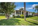 Two-story condo building with balconies and grassy area at 2522 Pine Ridge S Way # A2, Palm Harbor, FL 34684