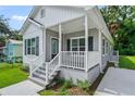 New construction home with a gray exterior and white trim at 3410 Lindell Ave, Tampa, FL 33610