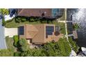 Property overview showcasing home with solar panels and waterfront access at 6316 Spoonbill Dr, New Port Richey, FL 34652