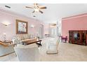 Spacious living room with light pink walls and comfortable seating at 4527 Secretariat Run, Spring Hill, FL 34609