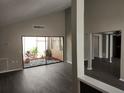 Bright living room with vinyl flooring and sliding glass doors leading to a private patio at 7832 Fox Den Row, Hudson, FL 34667