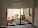Private courtyard with decorative stone and mature plants at 7832 Fox Den Row, Hudson, FL 34667