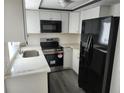 Modern kitchen featuring stainless steel appliances and quartz countertops at 7832 Fox Den Row, Hudson, FL 34667