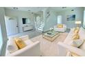 Elegant living room with white couches and gold accents at 4976 Trinidad Dr, Land O Lakes, FL 34639