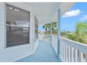 Enjoy relaxing views from this covered balcony with white railing at 13521 Stacey Dr, Hudson, FL 34667