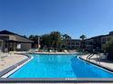 Inviting community pool with lounge chairs and sunny patio at 5123 Topaz Ln # 105, New Port Richey, FL 34652