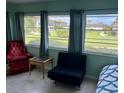 Cozy bedroom with window seating and view of lush landscaping at 5123 Topaz Ln # 105, New Port Richey, FL 34652